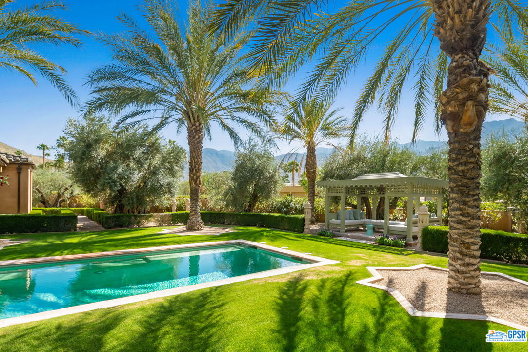 1650 Ave Sevilla Palm Springs, CA 92264 - Photo 14 of 74 a view of a swimming pool with an outdoor seating