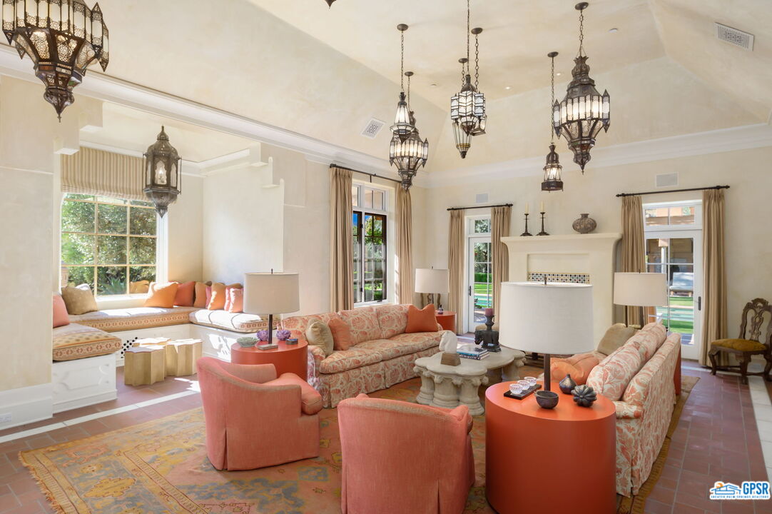 1650 Ave Sevilla Palm Springs, CA 92264 - Photo 27 of 74 a living room with furniture and floor to ceiling windows