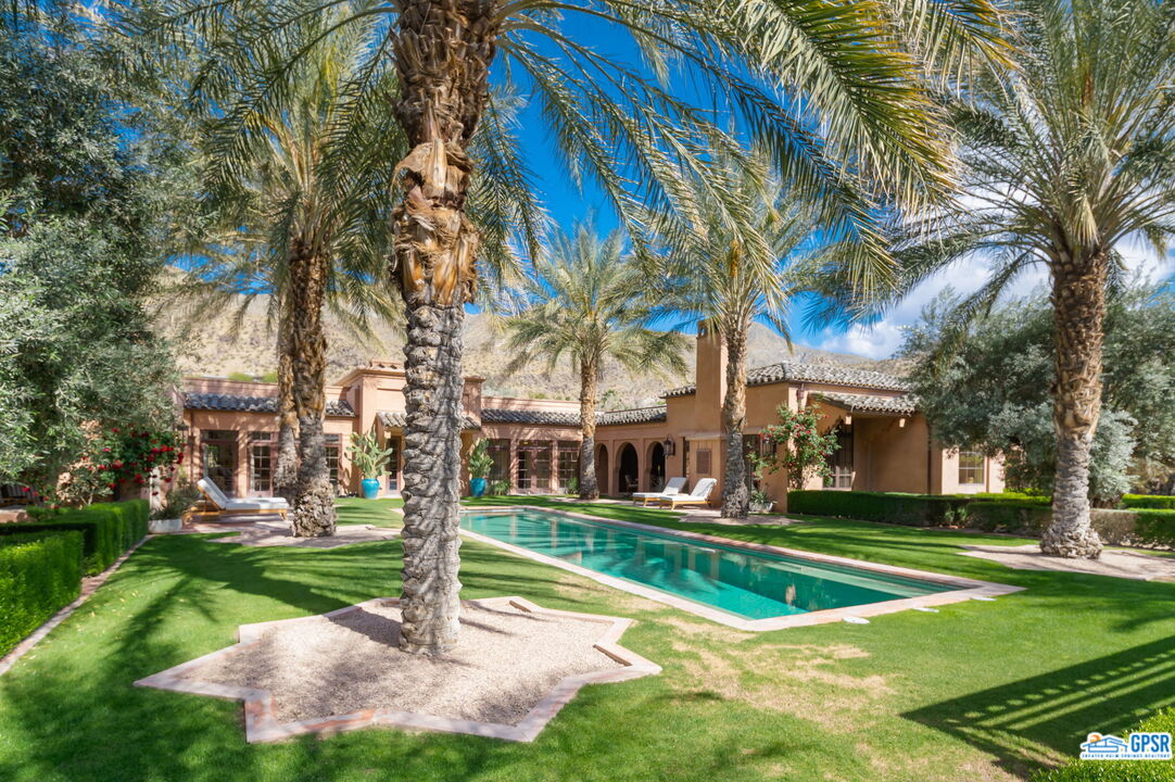 1650 Ave Sevilla Palm Springs, CA 92264 - Photo 3 of 74 a view of a house with a yard and palm trees