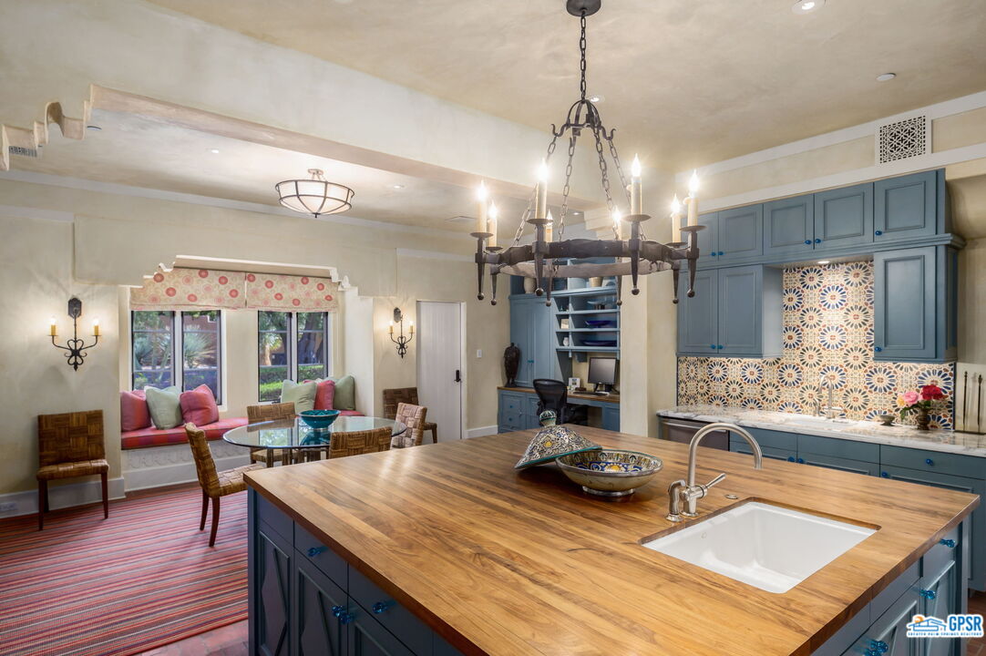 1650 Ave Sevilla Palm Springs, CA 92264 - Photo 32 of 74 a view of a dining room and livingroom with furniture wooden floor a chandelier