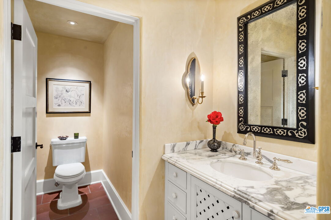 1650 Ave Sevilla Palm Springs, CA 92264 - Photo 40 of 74 a bathroom with a sink and a mirror with toilet