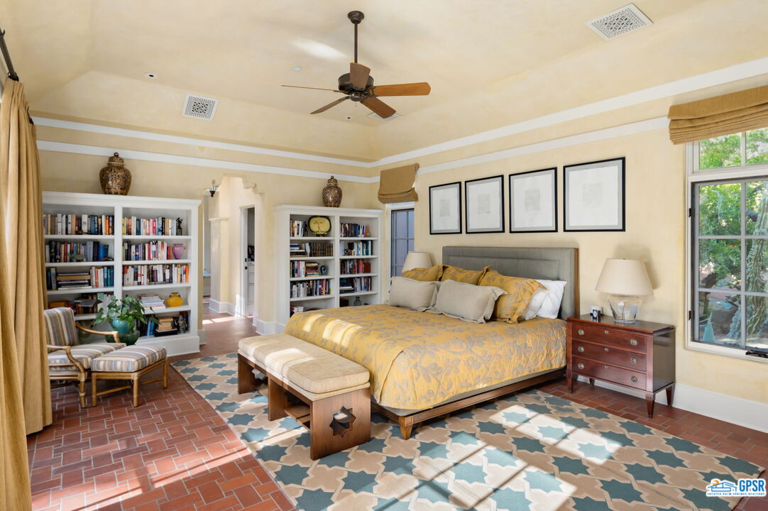 1650 Ave Sevilla Palm Springs, CA 92264 - Photo 44 of 74 a bedroom with a large bed and a book shelf