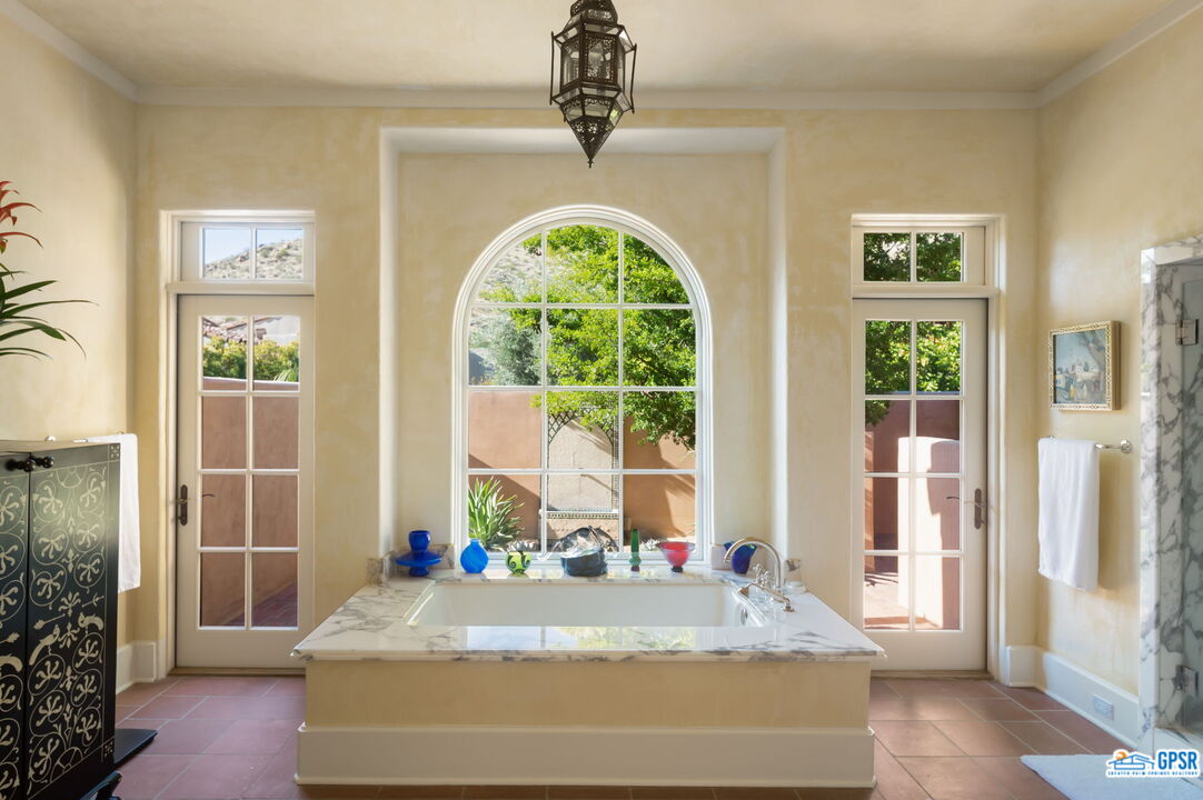 1650 Ave Sevilla Palm Springs, CA 92264 - Photo 47 of 74 a spacious bedroom with a bed and a window