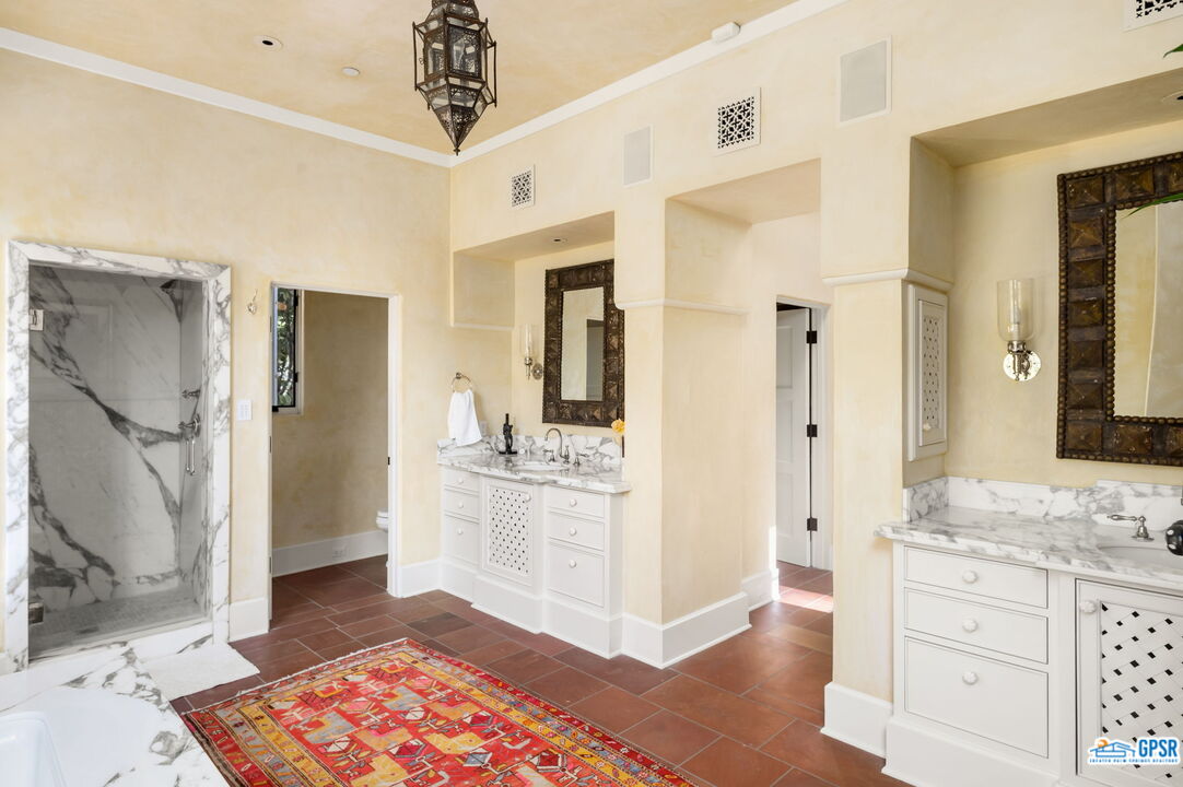 1650 Ave Sevilla Palm Springs, CA 92264 - Photo 50 of 74 a spacious bathroom with a granite countertop sink a mirror and a shower