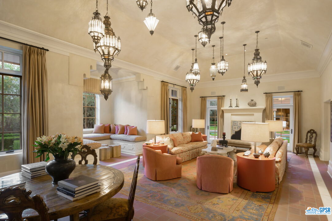 1650 Ave Sevilla Palm Springs, CA 92264 - Photo 61 of 74 a living room with fireplace furniture and a chandelier