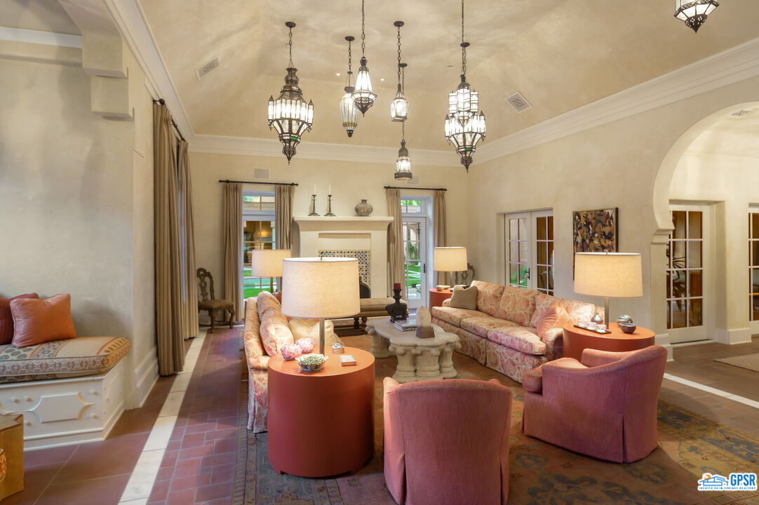 1650 Ave Sevilla Palm Springs, CA 92264 - Photo 63 of 74 a living room with fireplace furniture and a chandelier