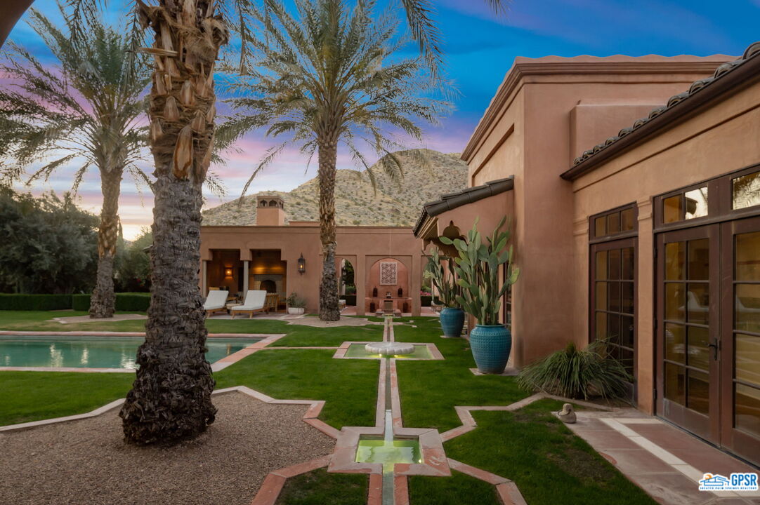 1650 Ave Sevilla Palm Springs, CA 92264 - Photo 64 of 74 a front view of a house with garden and trees