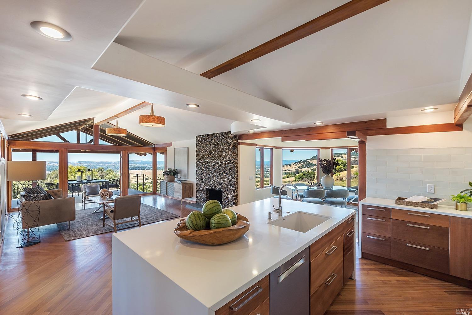 a kitchen with stainless steel appliances granite countertop a sink and wooden cabinets