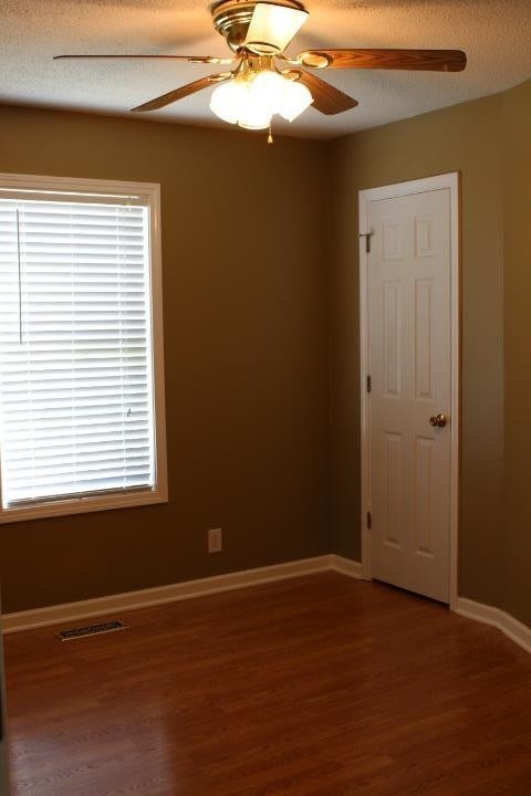 916 Granny White Road Clarksville, TN 37040 - Photo 12 of 19 a view of an empty room with a window and wooden floor