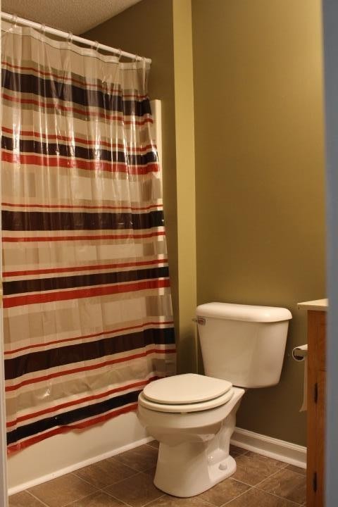 916 Granny White Road Clarksville, TN 37040 - Photo 16 of 19 a bathroom with a toilet and a shower curtain