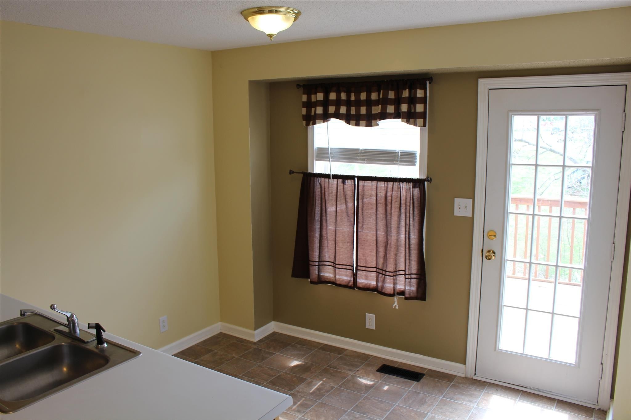 916 Granny White Road Clarksville, TN 37040 - Photo 7 of 19 a view of an empty room with a window