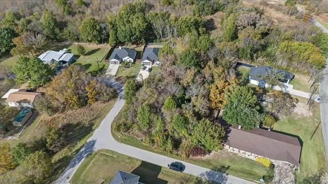 an aerial view of a residential houses with outdoor space