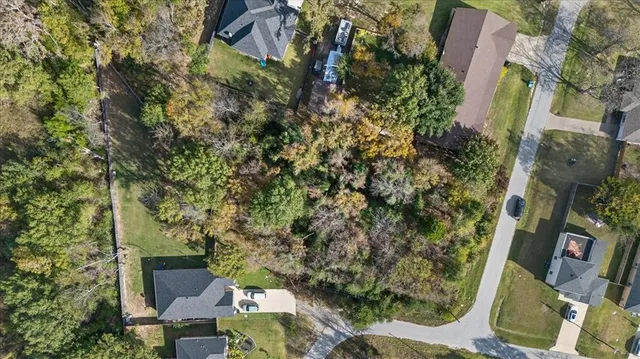 an aerial view of a house with a yard basket ball court and outdoor seating