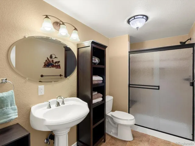 a view of a patio with a table and chairs under an umbrella