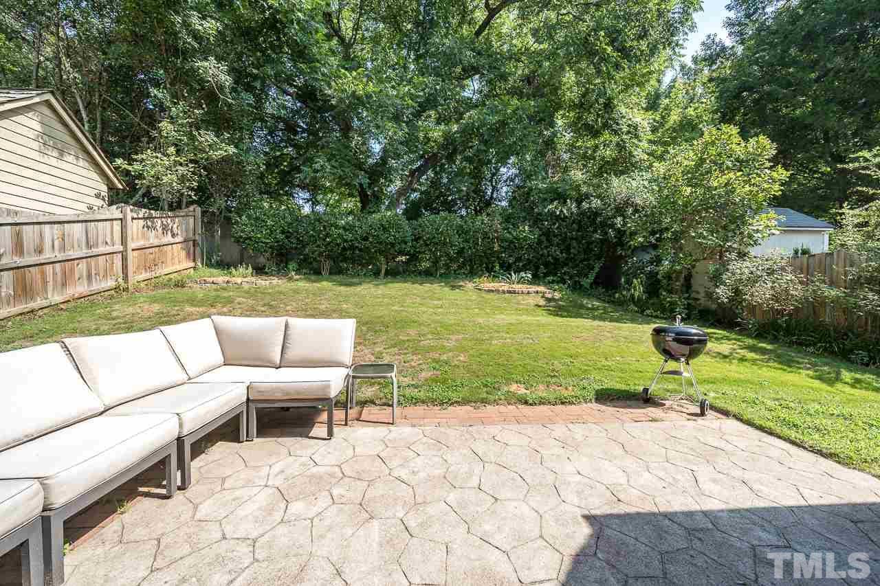 535 Pace Street Raleigh, NC 27604 - Photo 22 of 25 a view of a patio with lawn chairs floor to ceiling window and yard