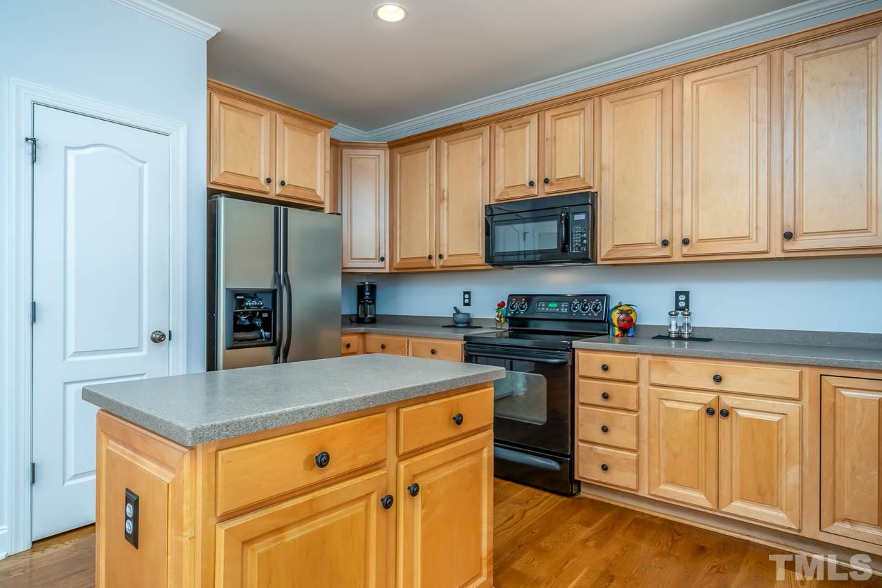 535 Pace Street Raleigh, NC 27604 - Photo 8 of 25 a kitchen with stainless steel appliances granite countertop a stove a refrigerator and a sink