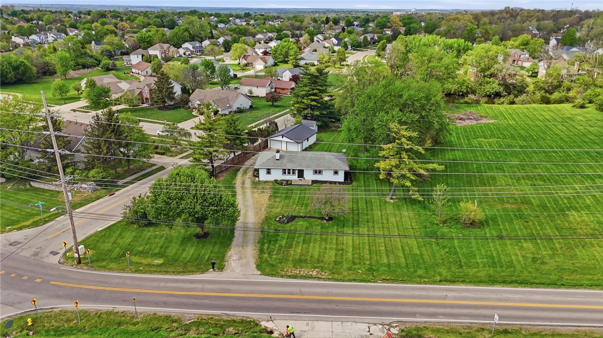3991 Benner Road Miamisburg, OH 45342 - Photo 4 of 44 An aerial view showcases a residential property nestled amidst lush greenery and suburban homes.