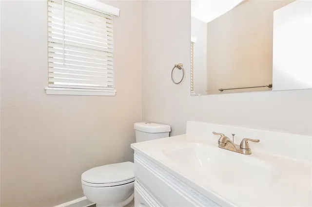 a white toilet sitting next to a bathroom sink