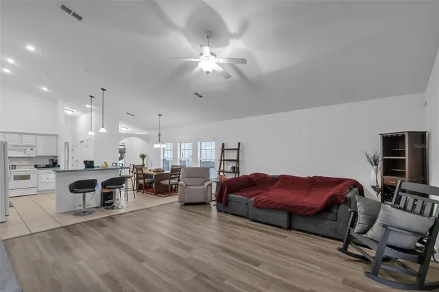 a bathroom with a sink vanity mirror bathtub and toilet
