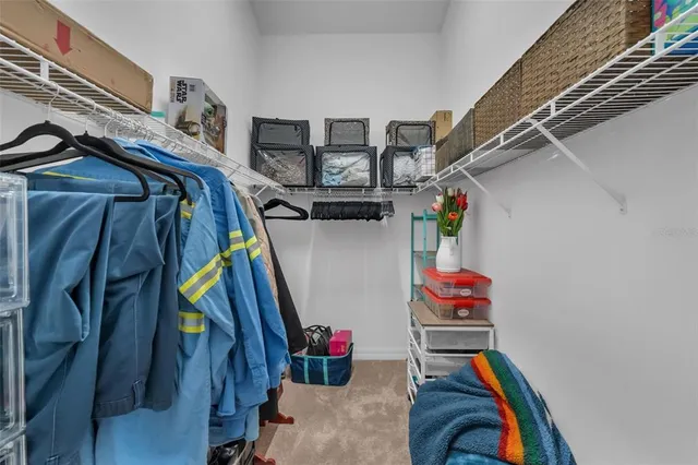 a view of a white house with a big yard and palm trees