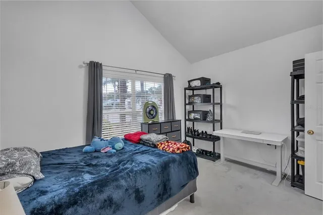 a view of a house with a yard and potted plants