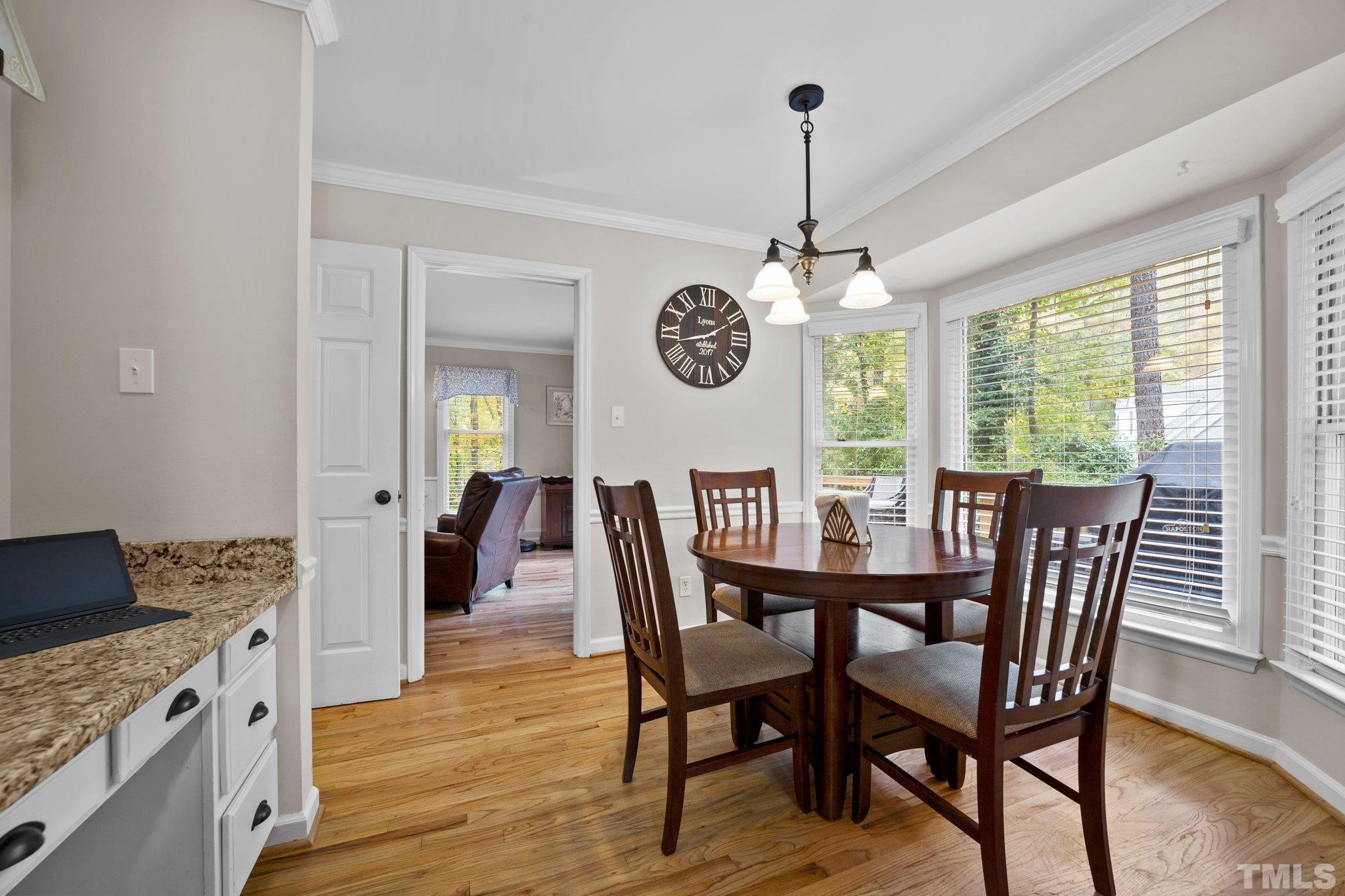 8709 Langtree Lane Raleigh, NC 27613 - Photo 16 of 49 a view of a dining room with furniture window and wooden floor
