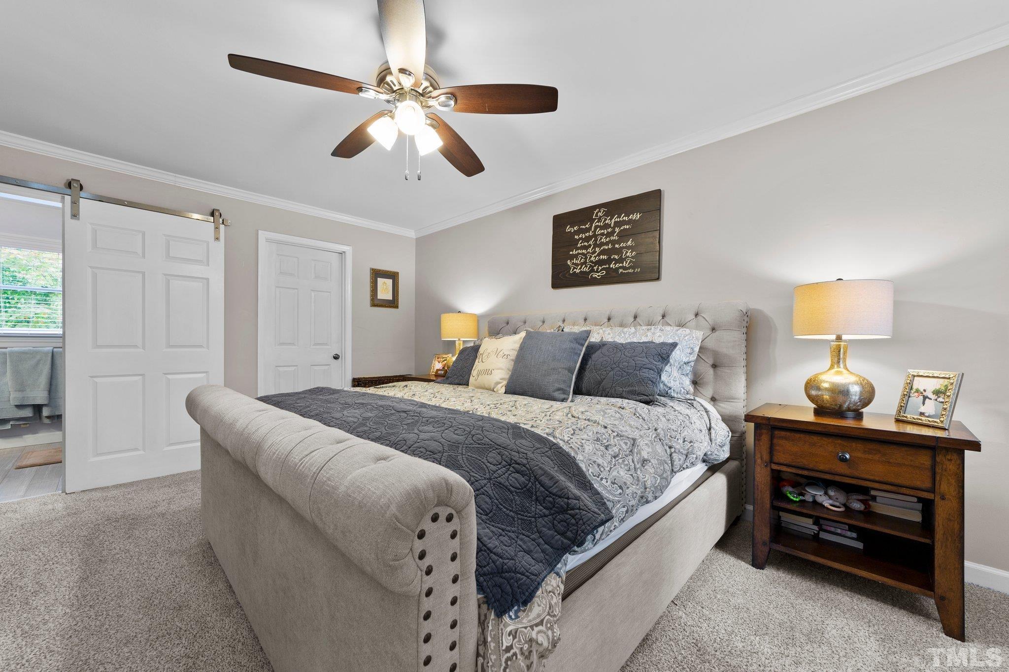 8709 Langtree Lane Raleigh, NC 27613 - Photo 21 of 49 a spacious bedroom with a bed and a ceiling fan