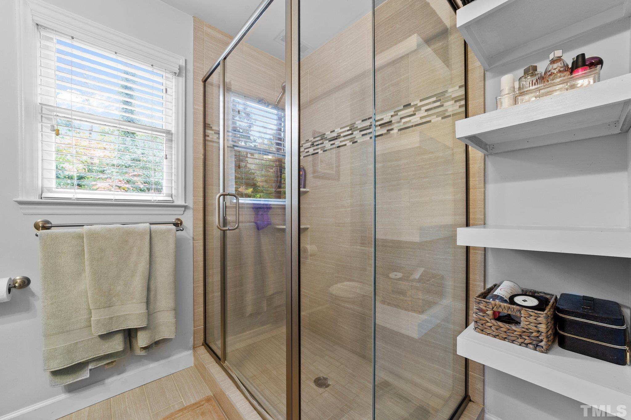 8709 Langtree Lane Raleigh, NC 27613 - Photo 23 of 49 a bathroom with a shower