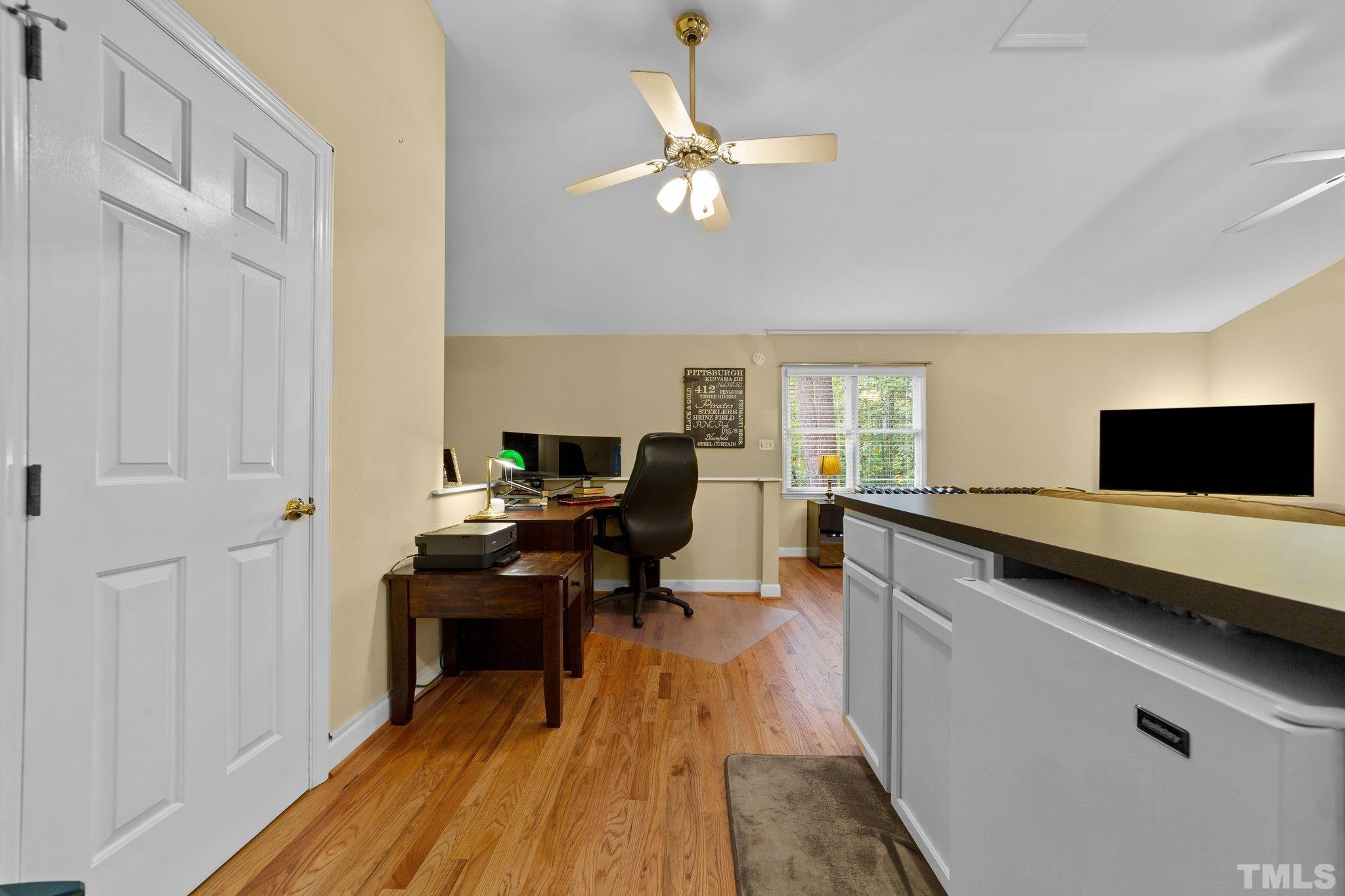 8709 Langtree Lane Raleigh, NC 27613 - Photo 30 of 49 a view of a workspace with wooden floor and a window