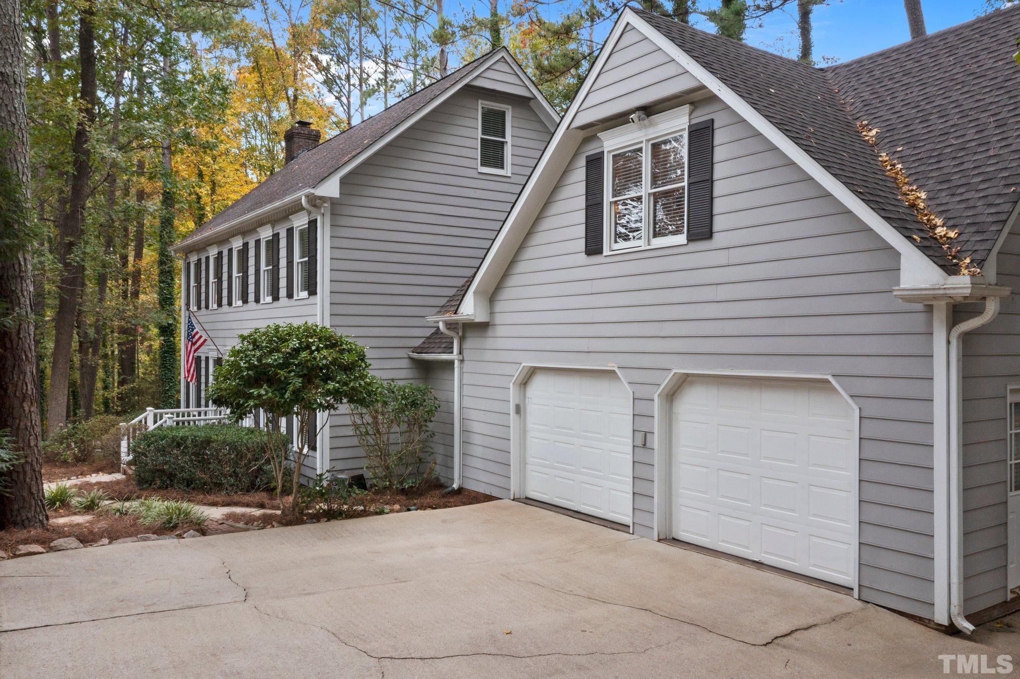 8709 Langtree Lane Raleigh, NC 27613 - Photo 3 of 49 a view of a house with a yard and garage