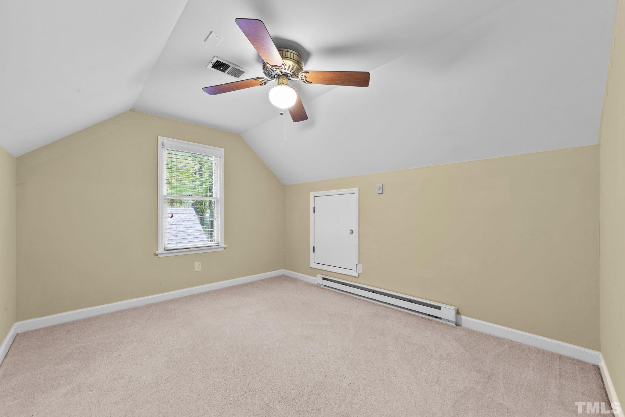 8709 Langtree Lane Raleigh, NC 27613 - Photo 33 of 49 an empty room with a window and a fan