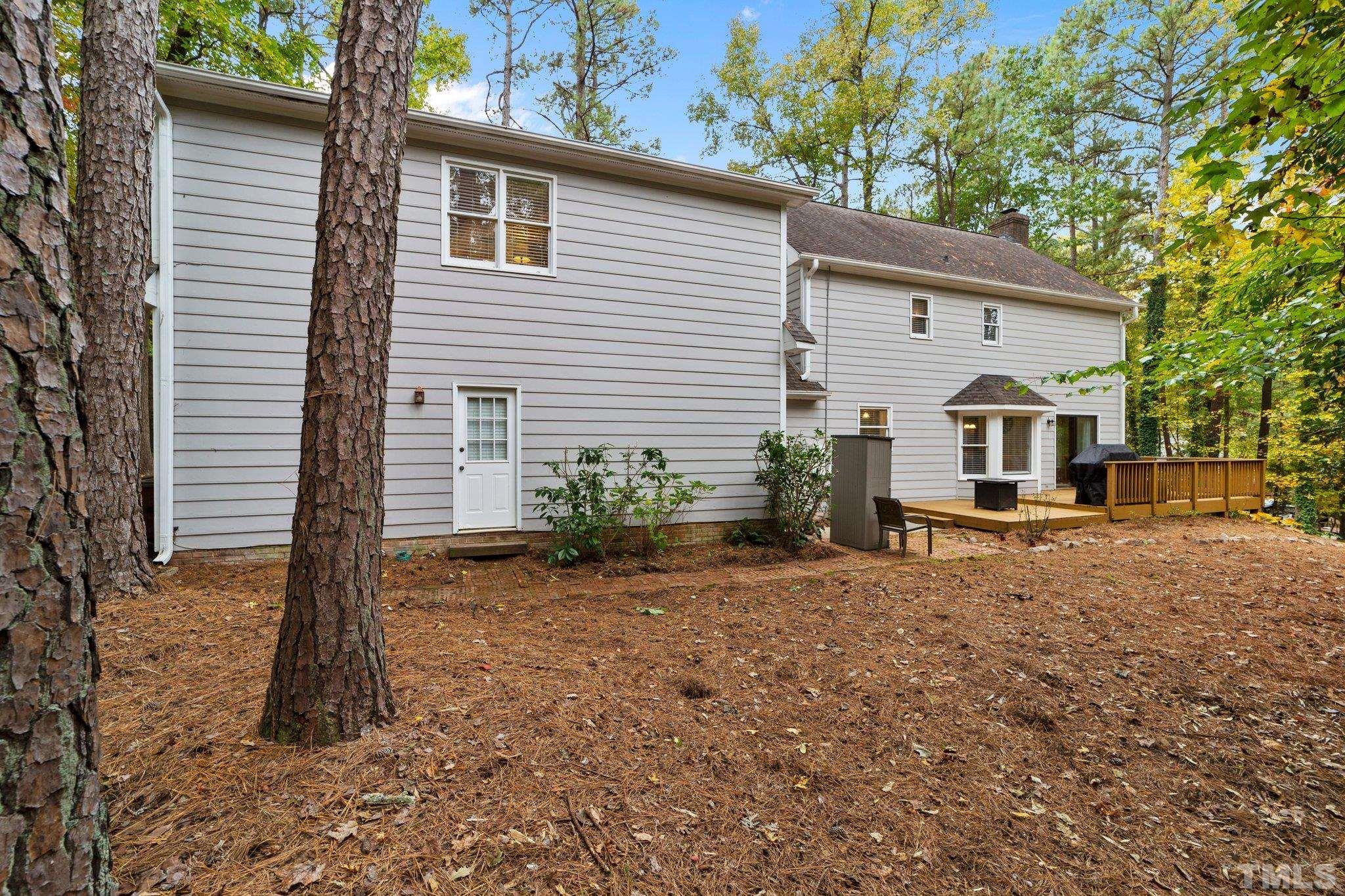 8709 Langtree Lane Raleigh, NC 27613 - Photo 37 of 49 a view of a house with backyard and trees