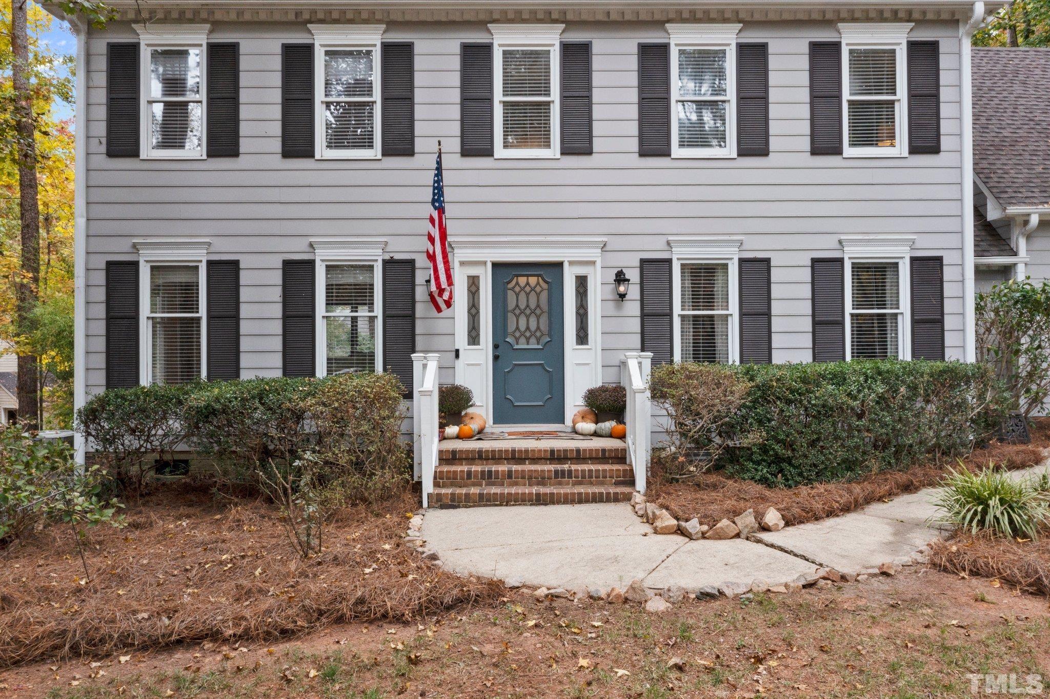 8709 Langtree Lane Raleigh, NC 27613 - Photo 4 of 49 a view of brick house with large windows and flower plants