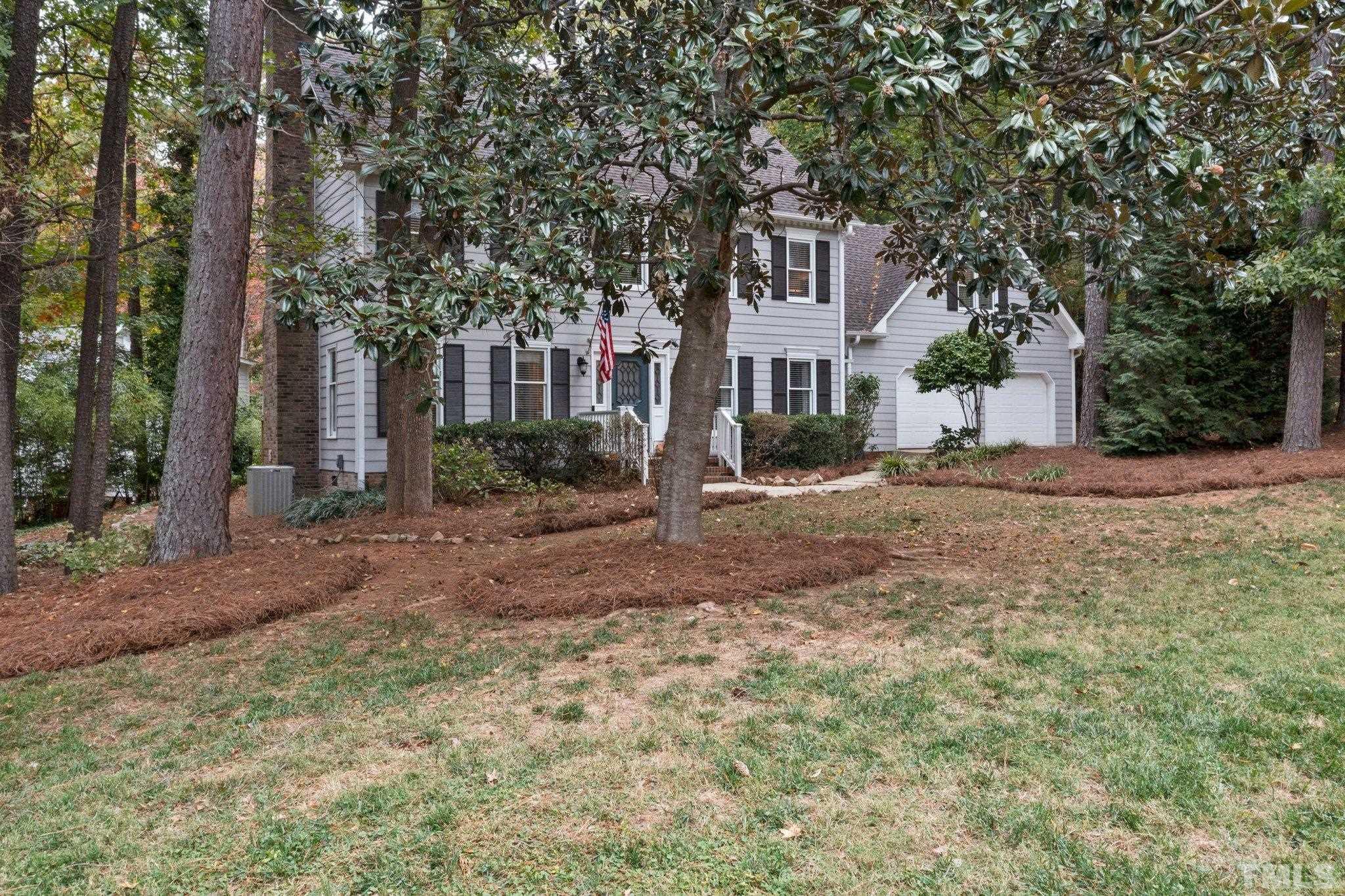 8709 Langtree Lane Raleigh, NC 27613 - Photo 47 of 49 a front view of a house with a yard
