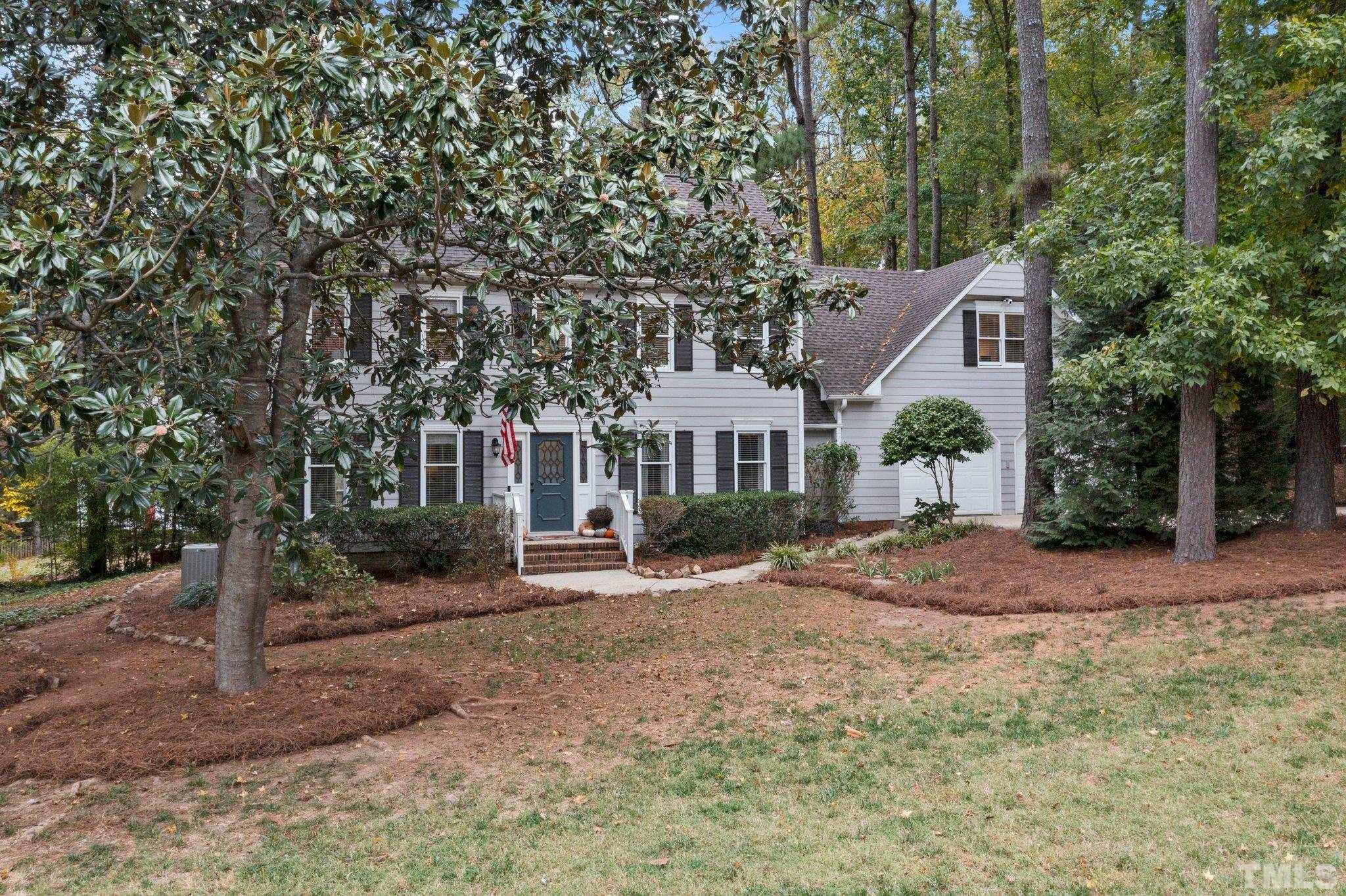8709 Langtree Lane Raleigh, NC 27613 - Photo 48 of 49 a front view of a house with a yard
