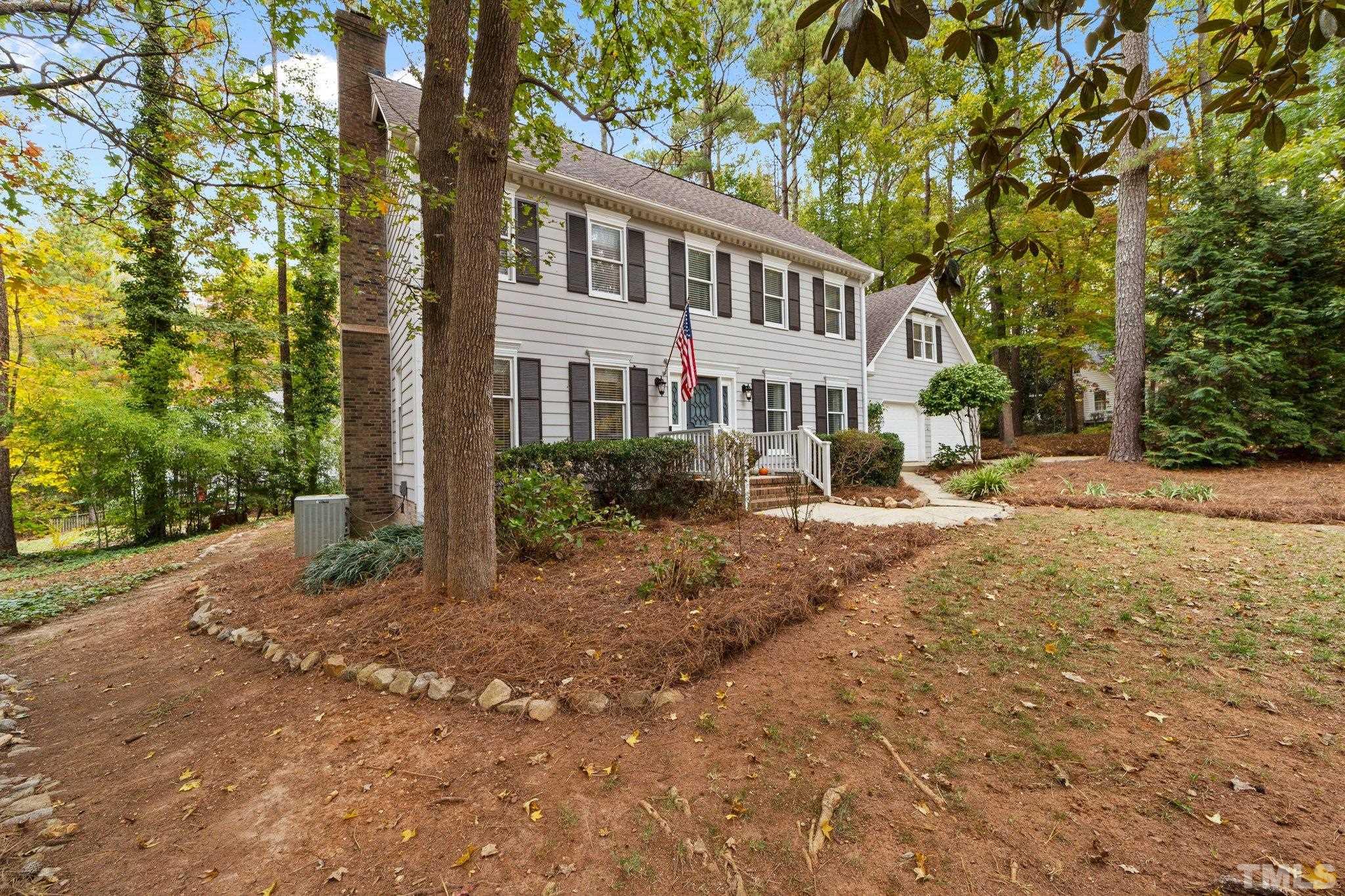8709 Langtree Lane Raleigh, NC 27613 - Photo 6 of 49 a view of a yard with a house in the background