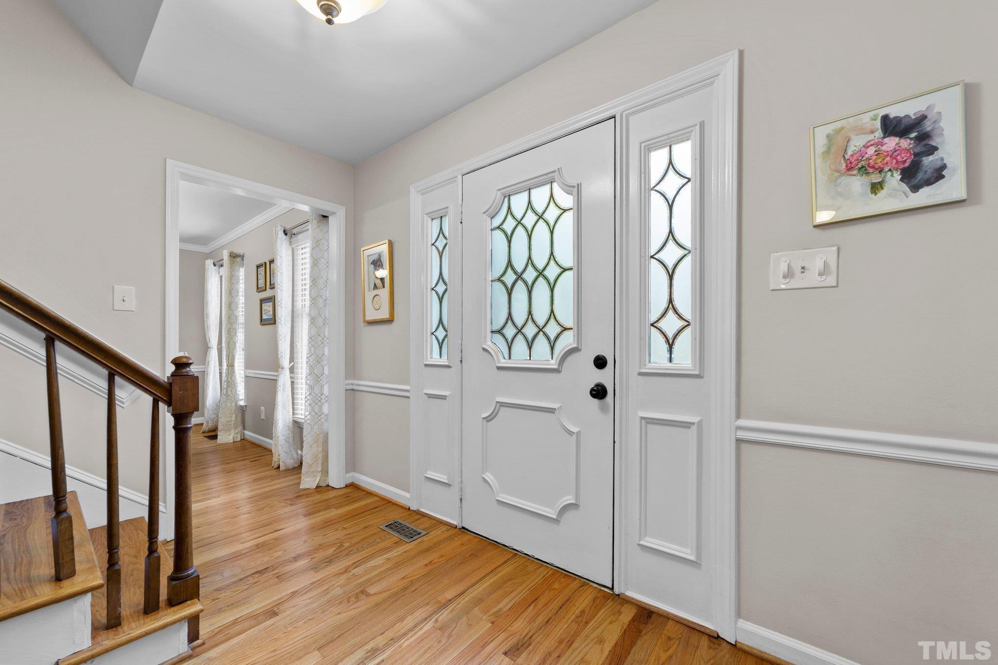 8709 Langtree Lane Raleigh, NC 27613 - Photo 7 of 49 a view of front door with wooden floor
