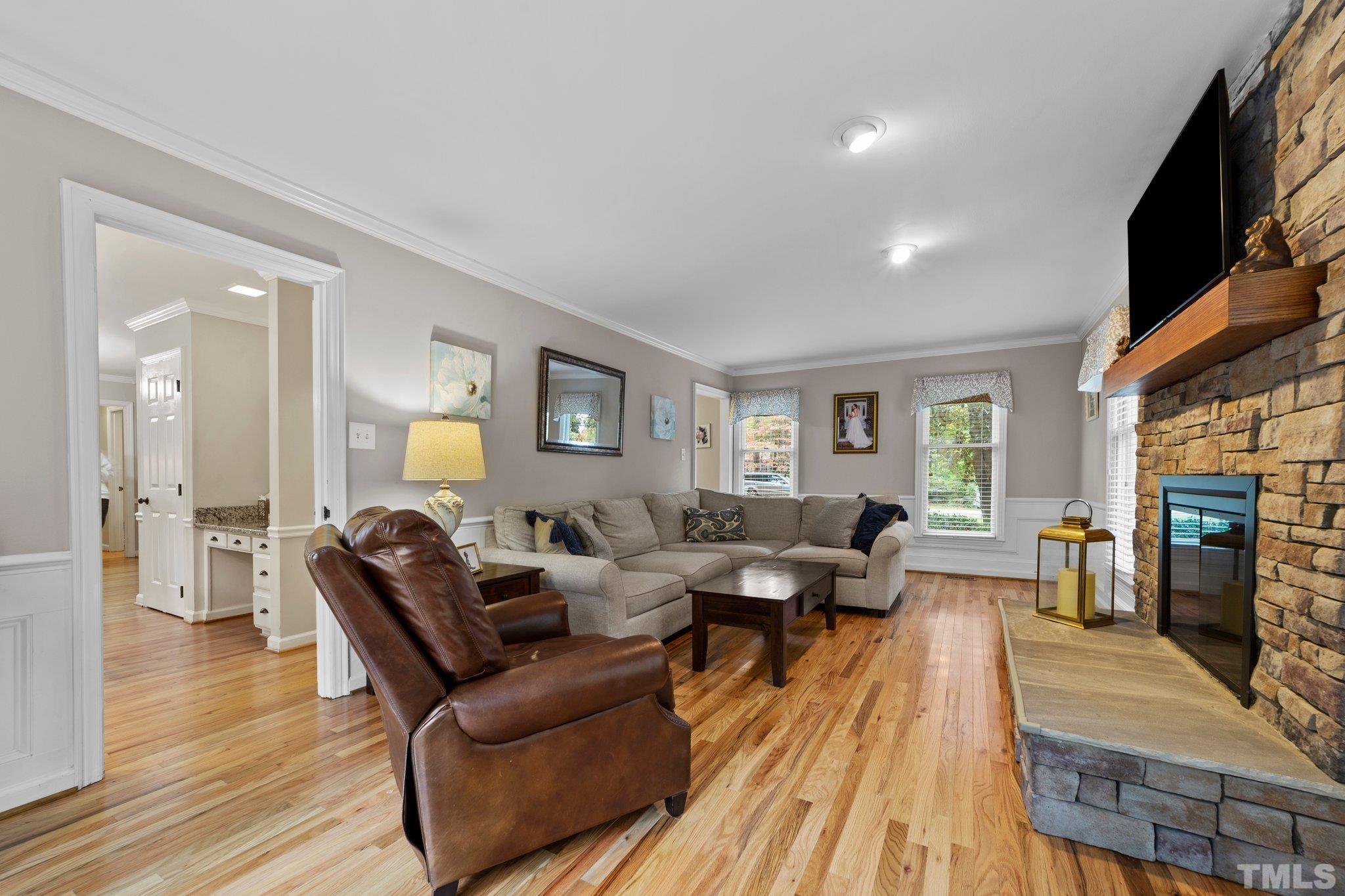 8709 Langtree Lane Raleigh, NC 27613 - Photo 8 of 49 a living room with furniture and a wooden floor