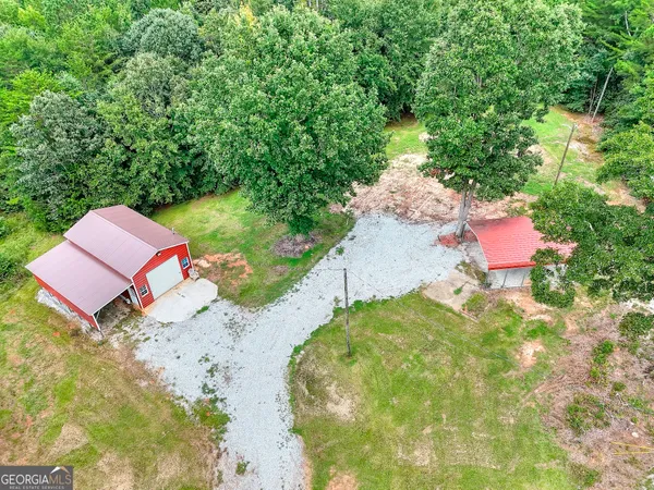an aerial view of a house with a yard and lake view