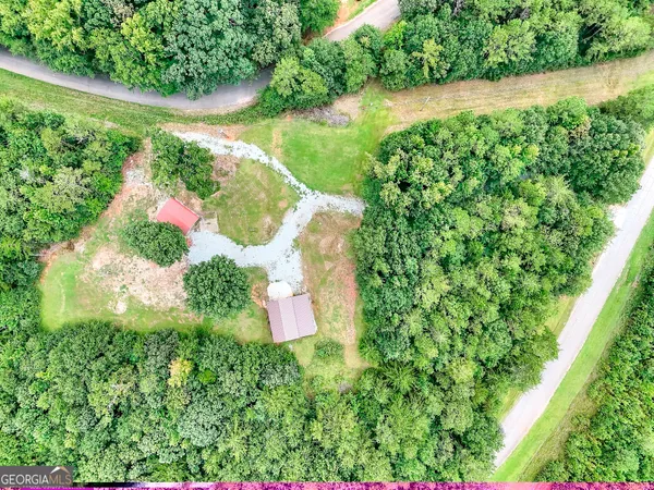 an aerial view of a house with a yard and lake view