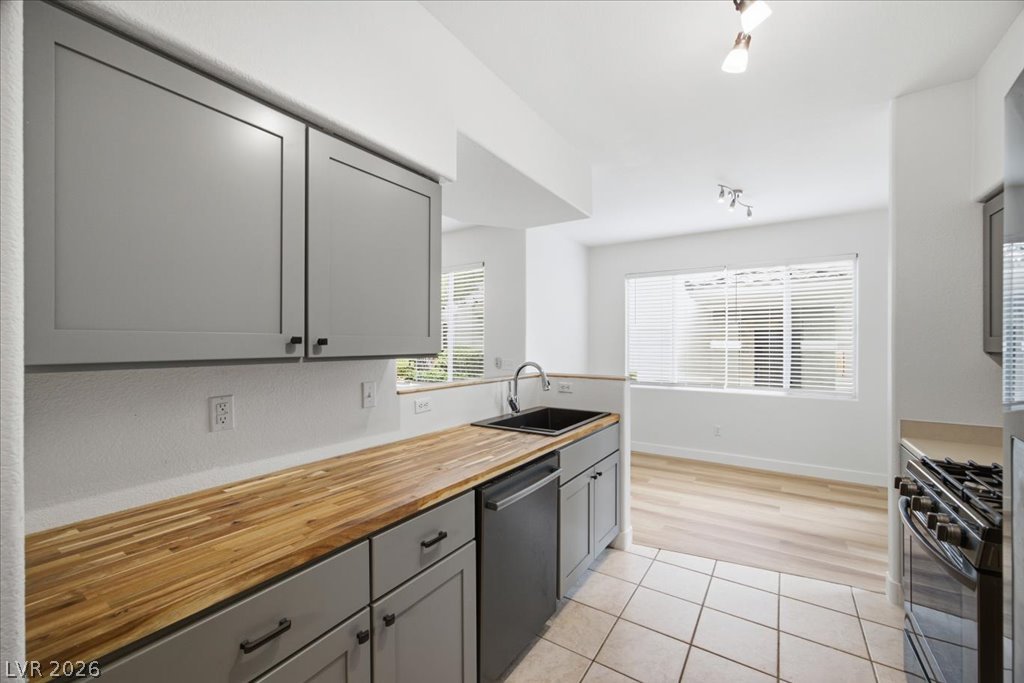 9050 West Warm Springs Road, Unit 1033 Las Vegas, NV 89148 - Photo 3 of 26 Butcher block counters adorn this kitchen, flowing into an inviting open concept living space.