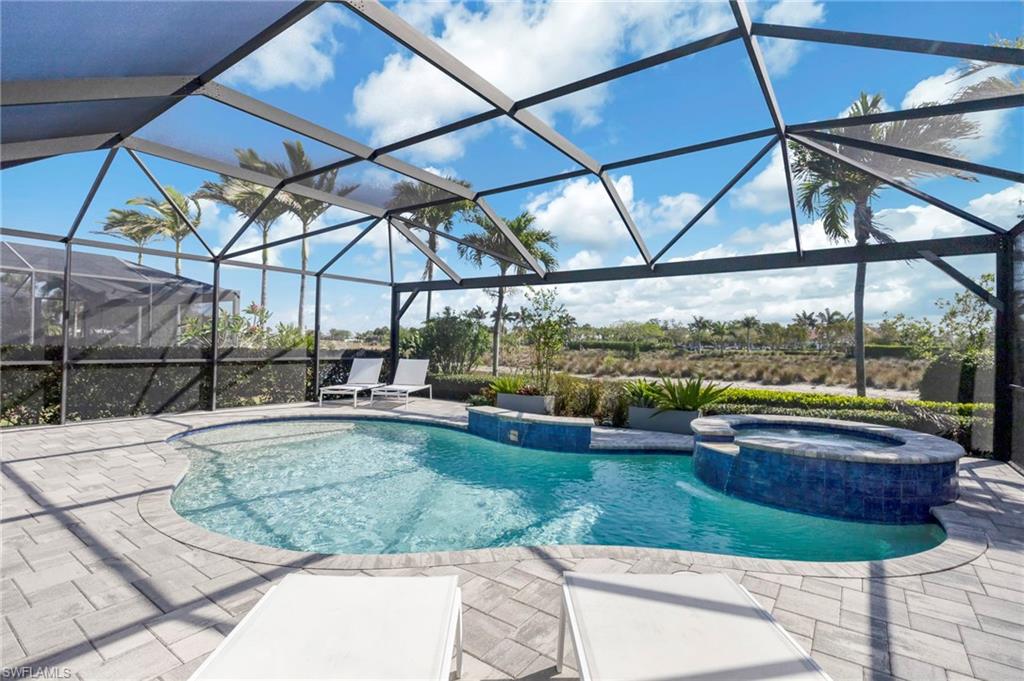 6466 Warwick Avenue Naples, FL 34113 - Photo 22 of 43 a view of a swimming pool with a yard