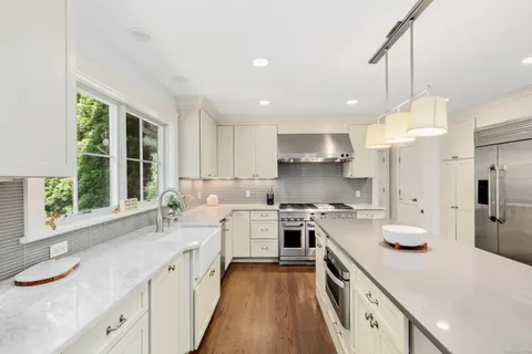 a kitchen with a sink stove and cabinets