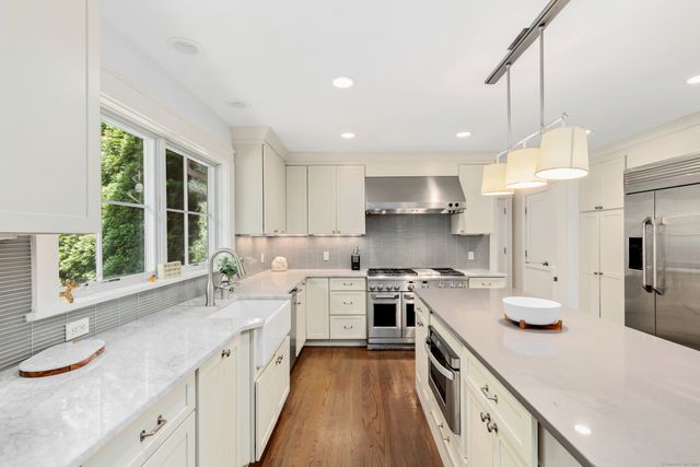 a kitchen with a sink stove and cabinets
