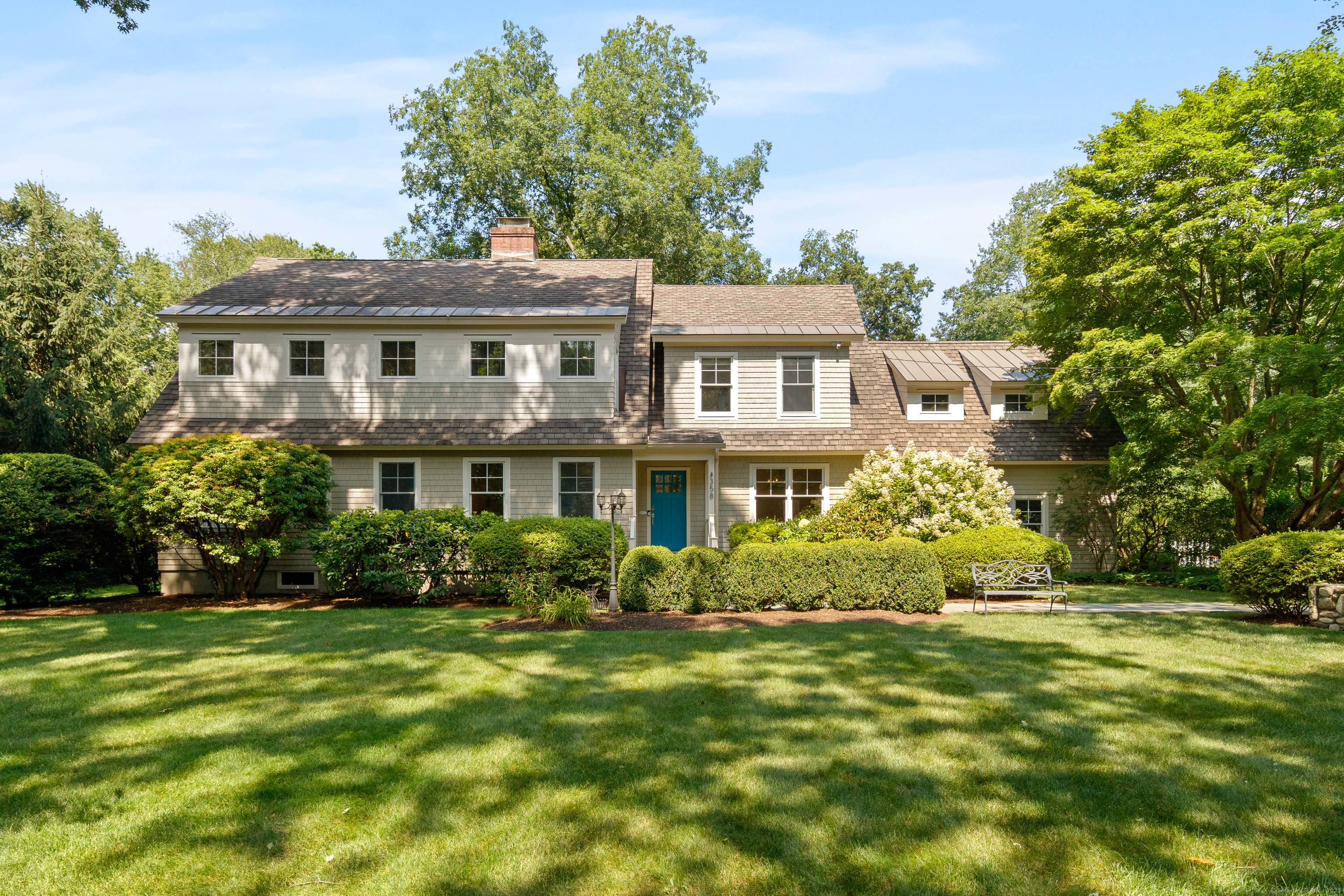 358 Hoyt Street Darien, CT 06820 - Photo 2 of 40 a front view of a house with a garden