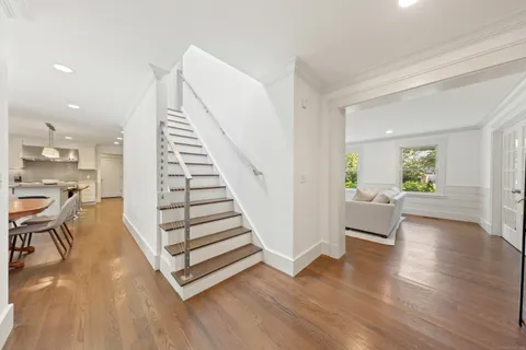 a view of entryway and hall with wooden floor