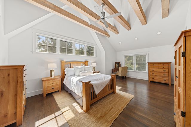 a bedroom with furniture and a large window