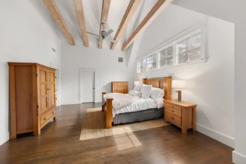 a bedroom with a bed and a large window