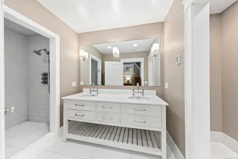 a bathroom with a sink double vanity and a mirror