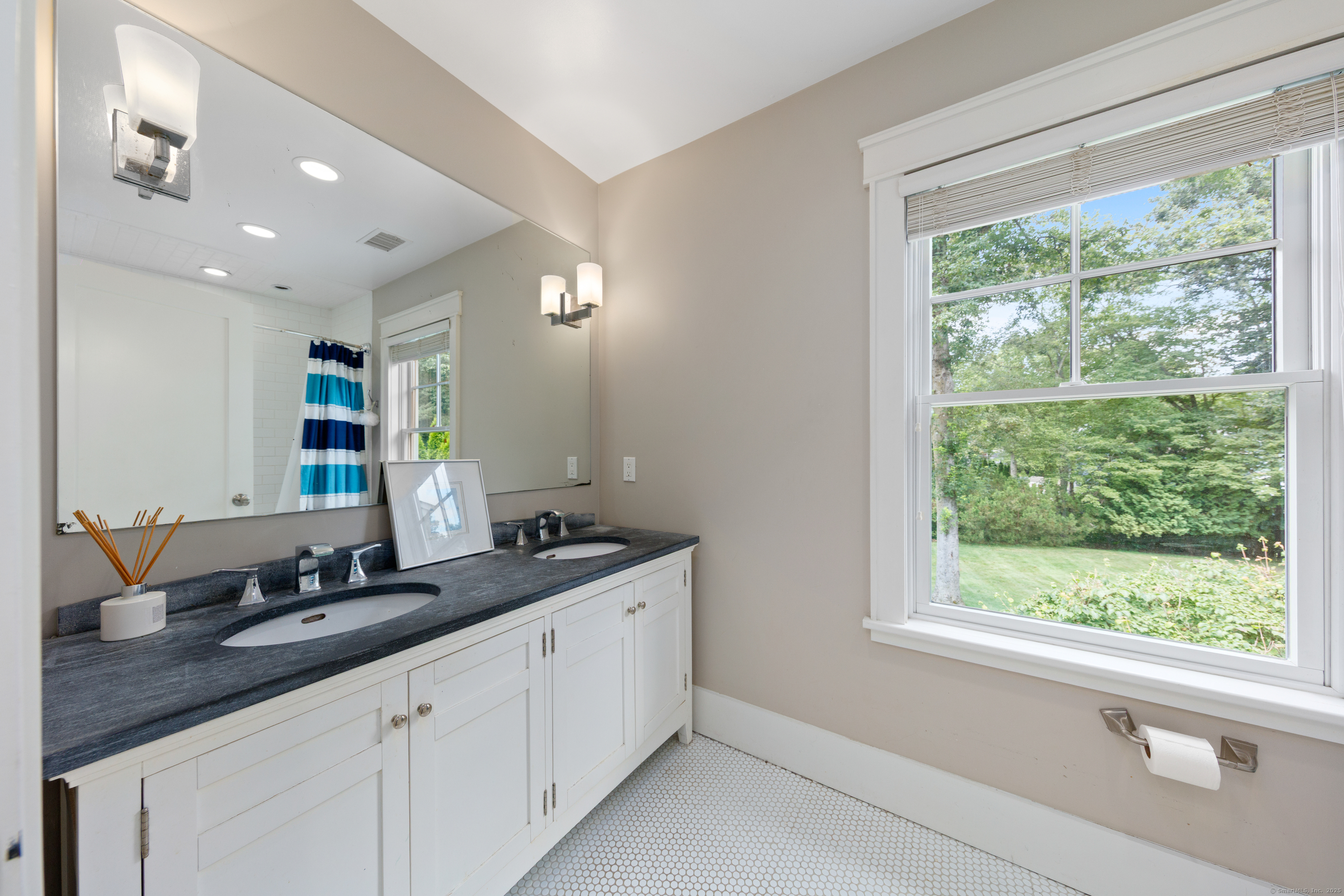 358 Hoyt Street Darien, CT 06820 - Photo 33 of 40 a bathroom with a double vanity sink and large window